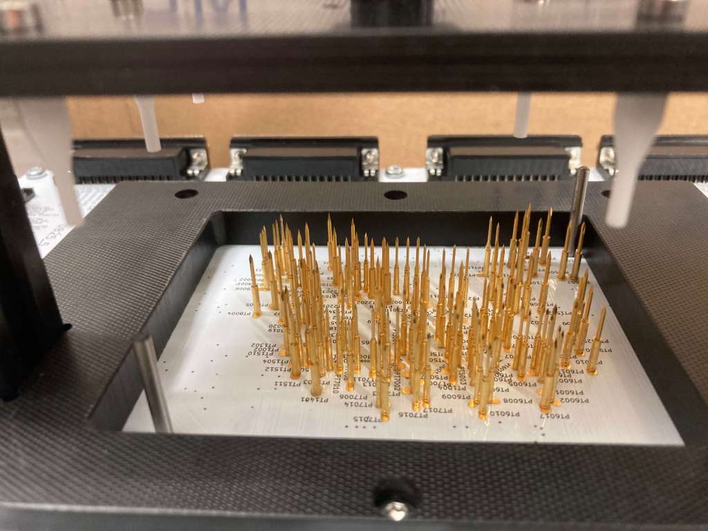 Bed-of-nails with routing, electronic test bench, electronic board testing, automated test solution, printed circuit board testing, custom test bench, routing for test bench, precision fixturing, optimization of electronic testing, productivity gains in electronics, industrial test automation, electronic test tooling, PCB quality control, electronic board validation, modular test interface, high repeatability testing, PCB defect detection, custom test pins, high-volume testing, industrial test solution, electronic test performance, controlled electronic assembly, in-line production integration, test bench manufacturing, test bench customization, reliable industrial connectivity, custom electronic tooling, automated electrical measurement, electronic tester precision, electronic test subcontracting