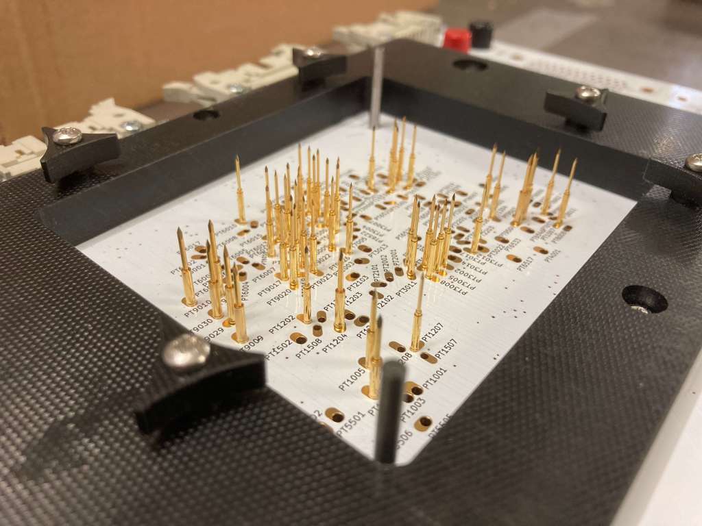 Bed-of-nails with routing, electronic test bench, electronic board testing, automated test solution, printed circuit board testing, custom test bench, routing for test bench, precision fixturing, optimization of electronic testing, productivity gains in electronics, industrial test automation, electronic test tooling, PCB quality control, electronic board validation, modular test interface, high repeatability testing, PCB defect detection, custom test pins, high-volume testing, industrial test solution, electronic test performance, controlled electronic assembly, in-line production integration, test bench manufacturing, test bench customization, reliable industrial connectivity, custom electronic tooling, automated electrical measurement, electronic tester precision, electronic test subcontracting