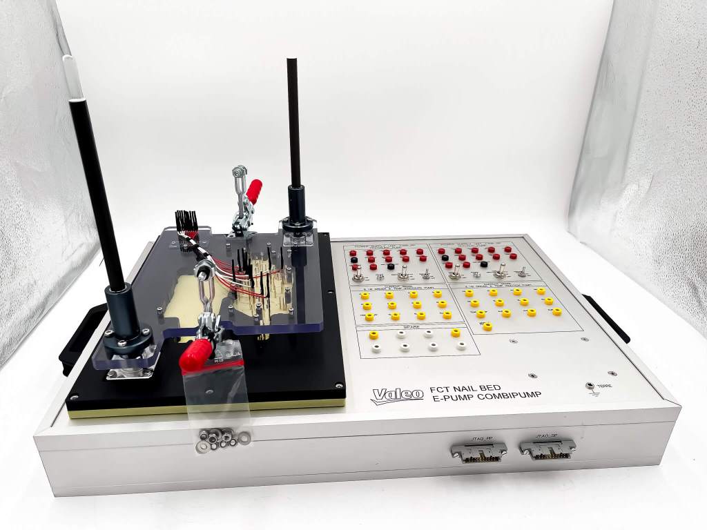 Bed-of-nails with routing, electronic test bench, electronic board testing, automated test solution, printed circuit board testing, custom test bench, routing for test bench, precision fixturing, optimization of electronic testing, productivity gains in electronics, industrial test automation, electronic test tooling, PCB quality control, electronic board validation, modular test interface, high repeatability testing, PCB defect detection, custom test pins, high-volume testing, industrial test solution, electronic test performance, controlled electronic assembly, in-line production integration, test bench manufacturing, test bench customization, reliable industrial connectivity, custom electronic tooling, automated electrical measurement, electronic tester precision, electronic test subcontracting